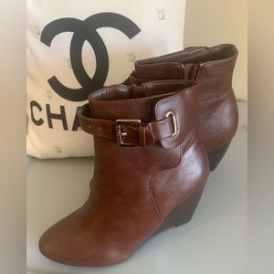 Brown wedge heel boot. Adjustable strap at ankles